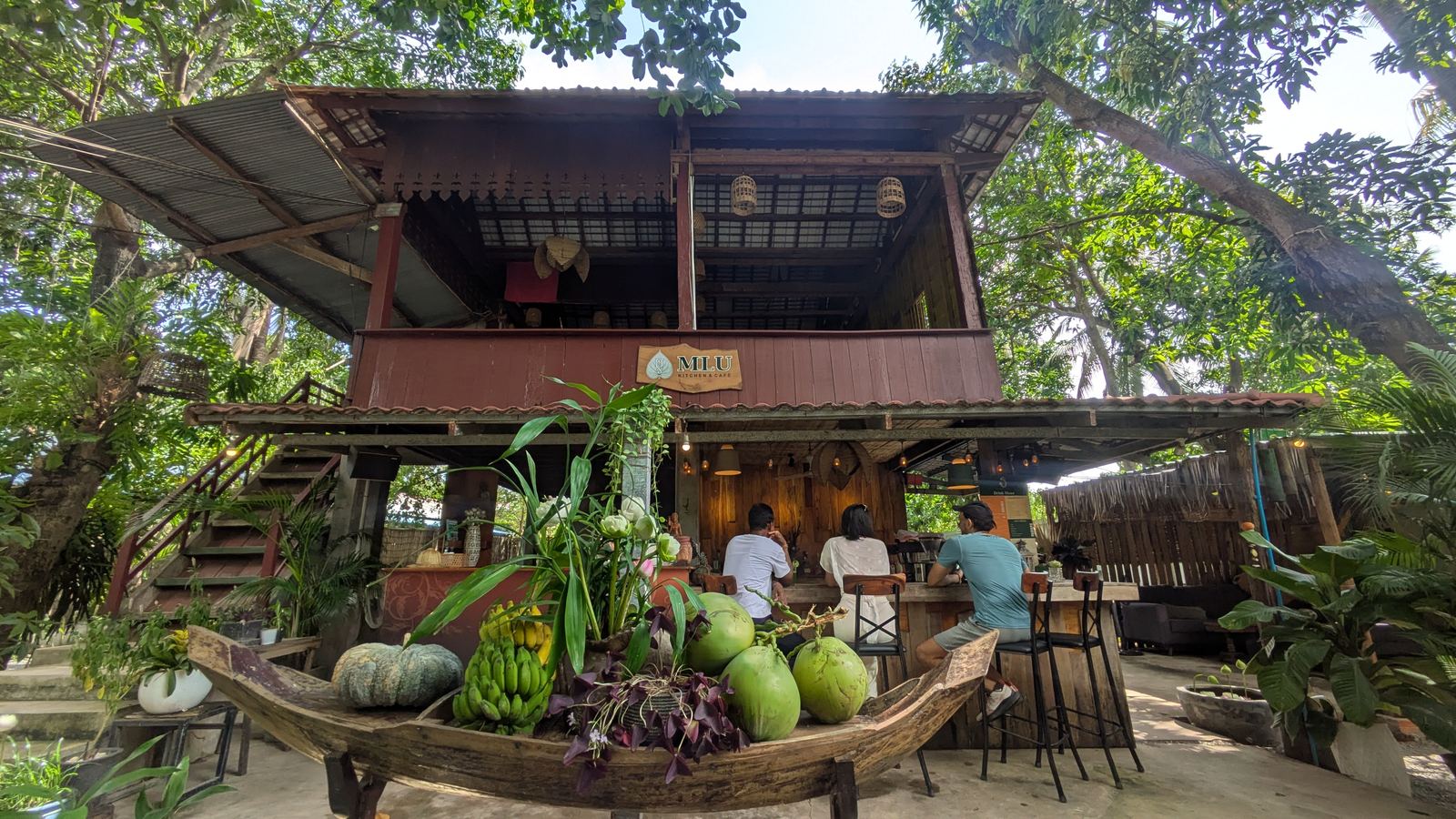 The wooden house with a boat full of fruit in front